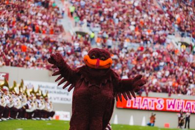 Hokie Bird standing in front of a crowd at a Virginia Tech home football game