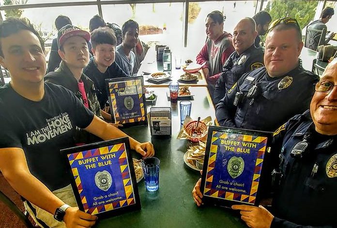 Officers eat with students during Buffet with the Blue
