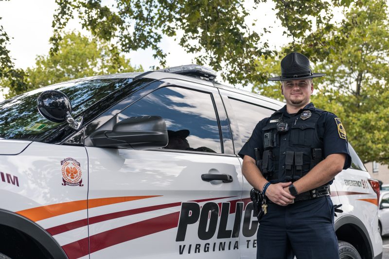 Officer Austin Shanks next to a patrol vehicle