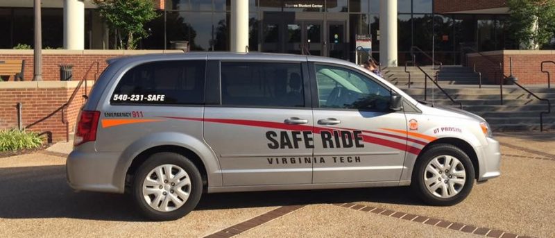 A minivan with the logo Safe Ride is parked in front of Squires Student Center.